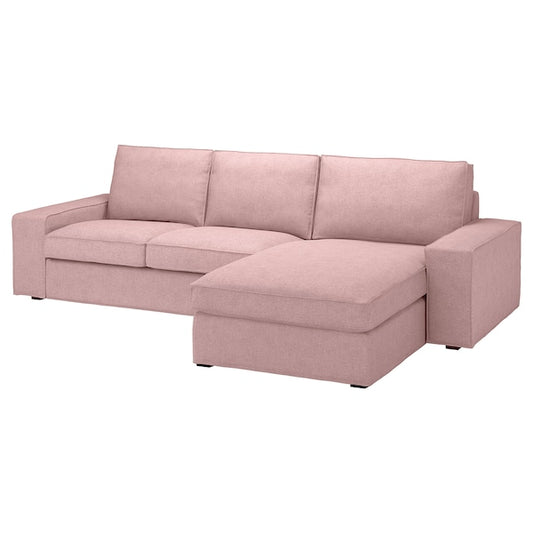 The KIVIK Sofa with Chaise is a pink L-shaped sofa featuring three back cushions and an extended lounge section on the right. Its minimalist design, upholstered in a soft fabric, makes it ideal for a modern living room.