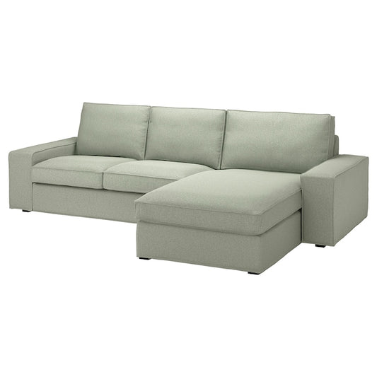 The KIVIK Sofa with Chaise is a light gray L-shaped sectional featuring three backrest cushions and a chaise lounge on the right. It boasts a modern design with wide armrests and blocky feet.