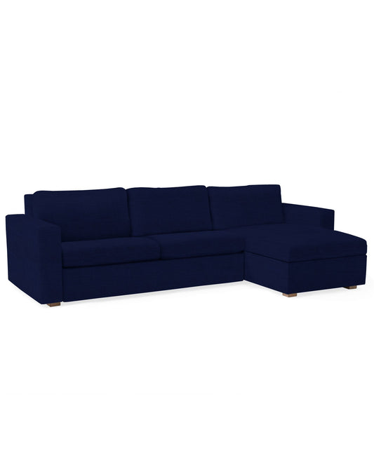 The Conover Sleeper Chaise Sectional is a dark blue sofa featuring a right-side chaise. It showcases low, clean lines and simple cushions, set against a plain white background.