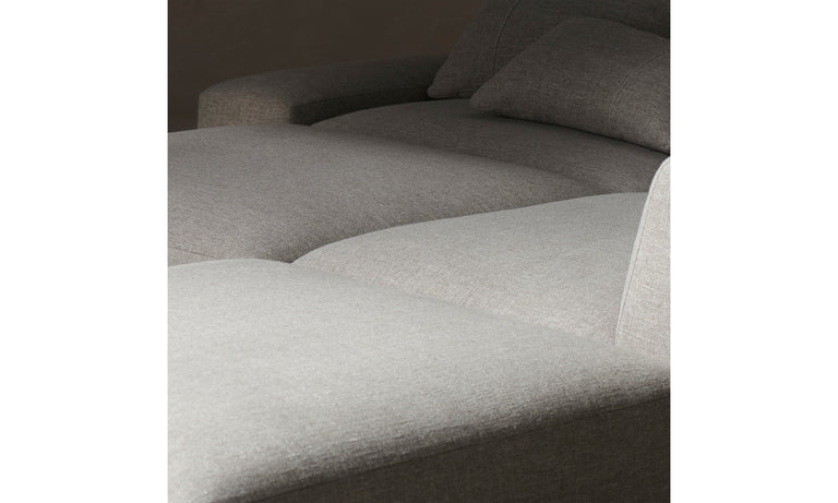 Close-up of The Breuer Modular Chaise Armless Sectional 114" in Belgian Linen Agate, featuring plush cushions that emphasize its smooth texture and minimalist design. The image highlights the sectional's inviting and comfortable appearance.