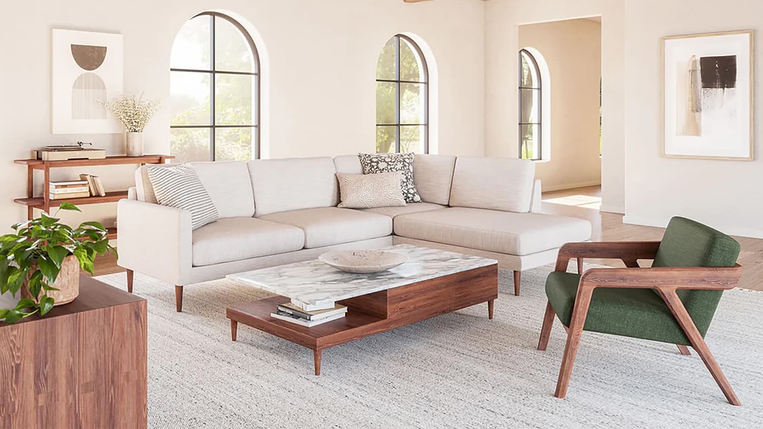 A contemporary living room with a light cream sectional sofa, a green armchair, and a marble-top wooden coffee table. Large arched windows and minimalistic decor, including potted plants and abstract artwork, enhance the airy and modern aesthetic.