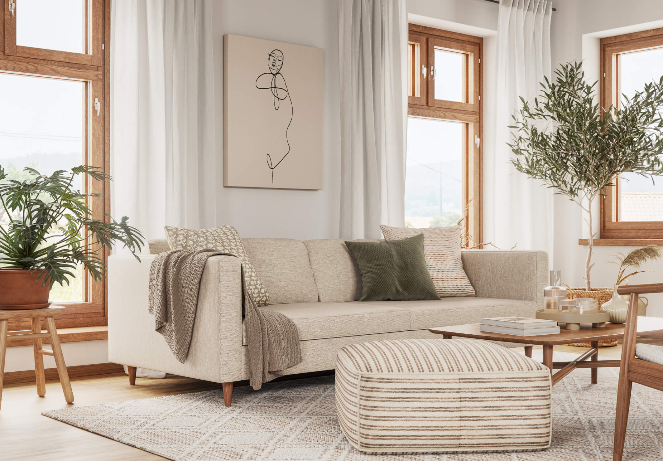 A bright living room with large windows features a beige sectional sofa adorned with various pillows and a throw blanket. A striped ottoman sits on a patterned rug in front of the sofa, and potted plants are placed around the room. A minimalist wall art hangs above the sofa.