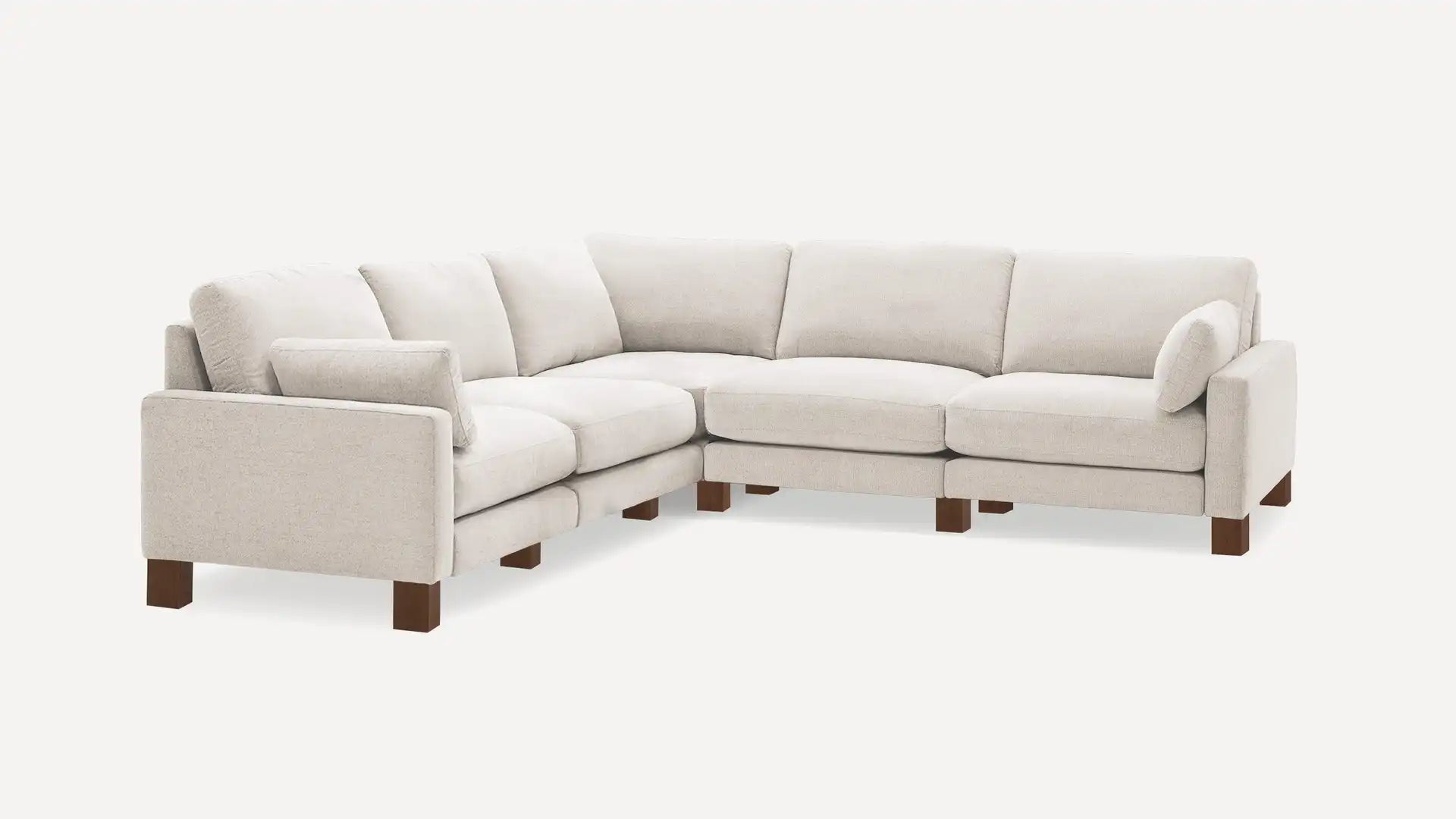 The Union Fabric Modular 5-Seat Sofa Sectional is a light beige L-shaped sectional with plush cushions and dark wooden legs, perfectly displayed against a plain white background. This contemporary piece is crafted for both comfort and style.