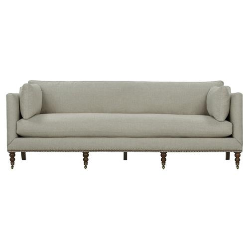 Presenting the Madeline French Grey Upholstered Sofa, a modern piece with clean, straight lines and accented by two cylindrical side cushions. This large sofa showcases wooden legs designed in a traditional style and features brass casters and nailhead detailing.