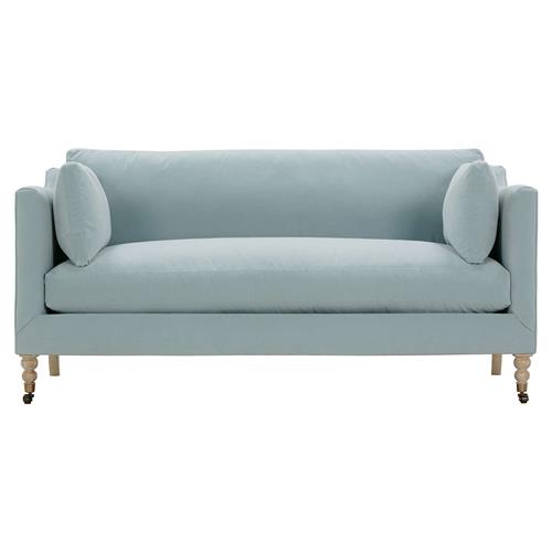 Introducing the Madeline French Grey Sofa: a spacious upholstered piece featuring two matching round pillows. This sofa showcases a modern design with elegant brown wooden legs ending in brass casters, creating a stylish and functional addition to any living room.