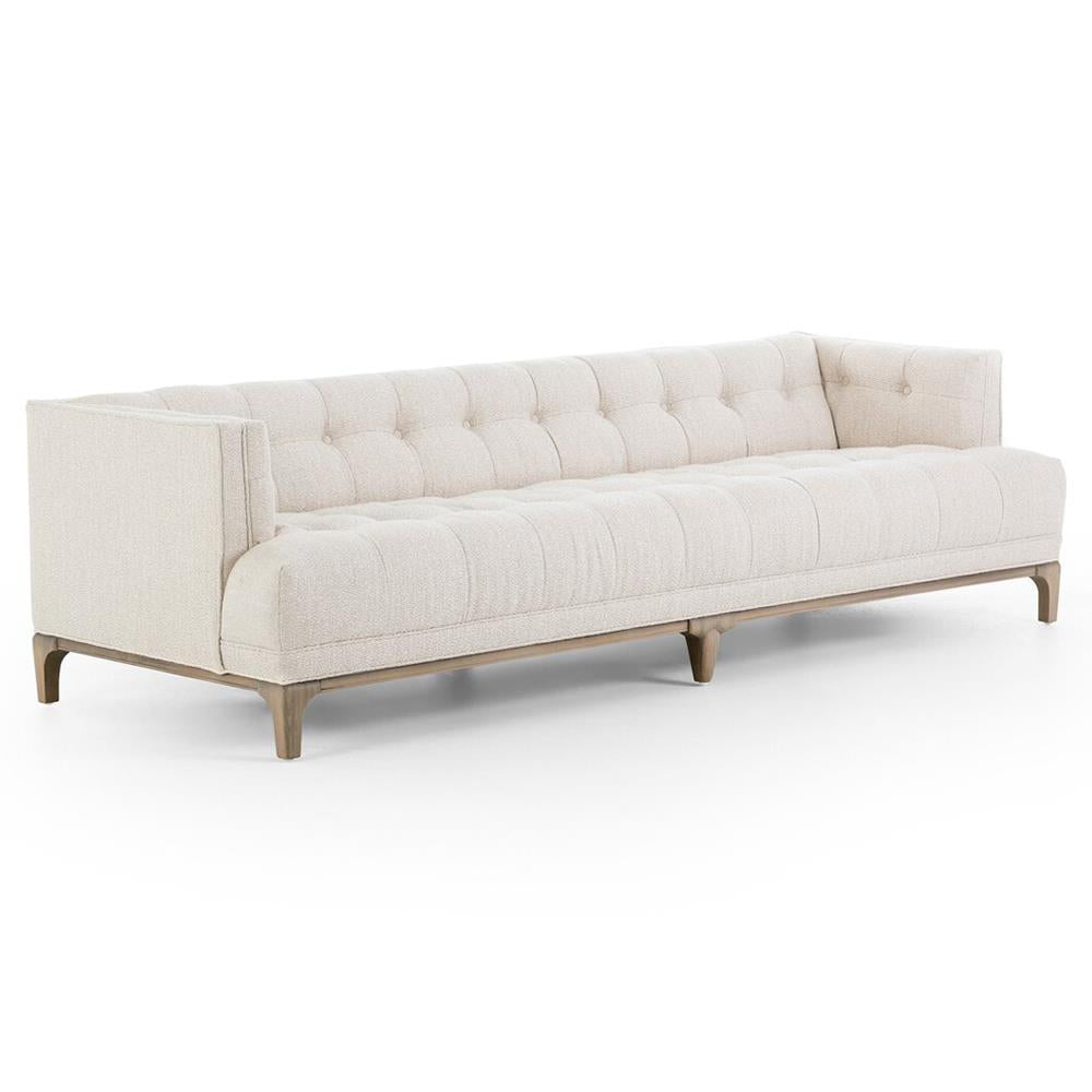 A green velvet mid-century modern sofa featuring button-tufted cushions and a brown wooden frame.