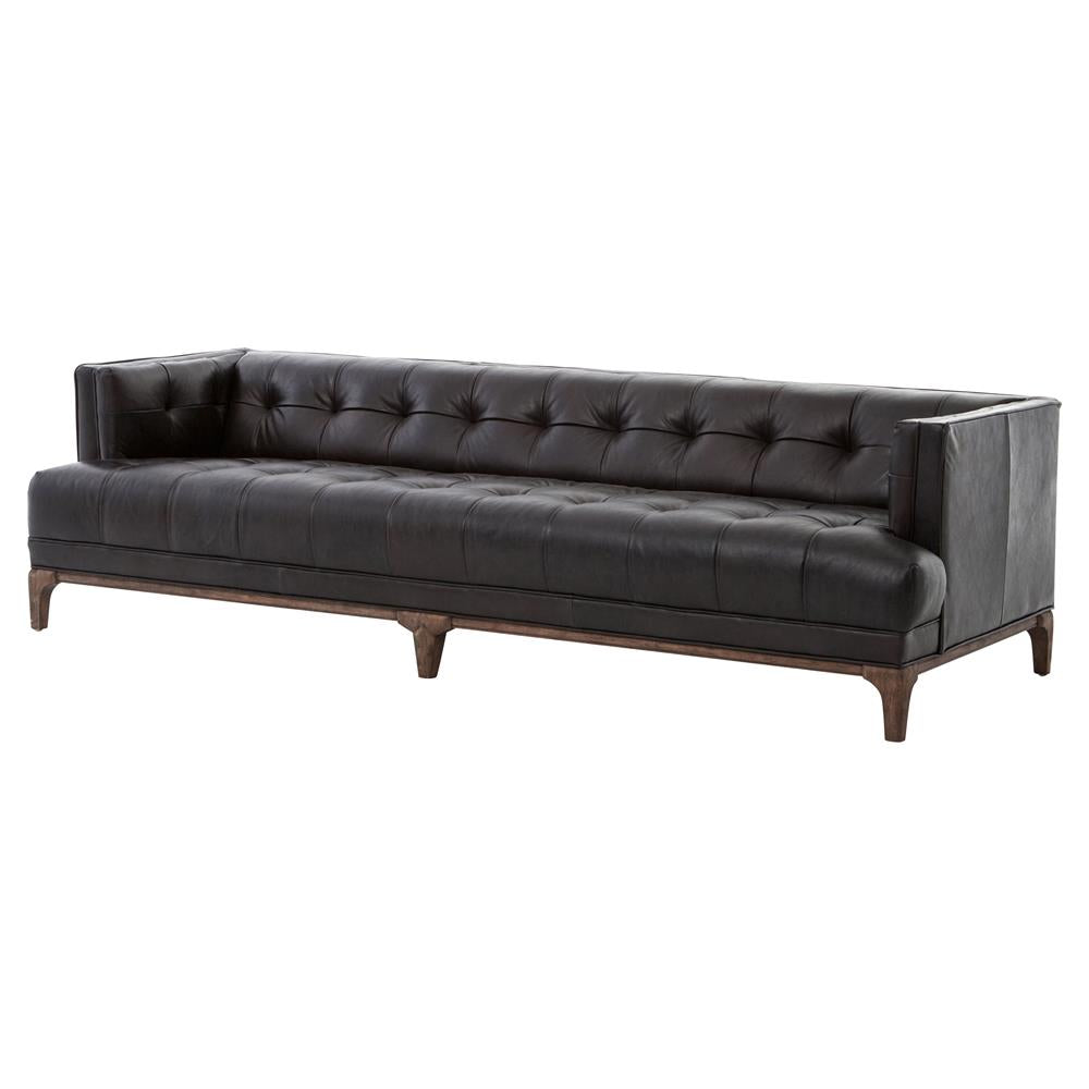 Product Description: A green velvet sofa with a tufted design and low backrest. It features square armrests and a brown wood frame, offering a sleek and modern look.