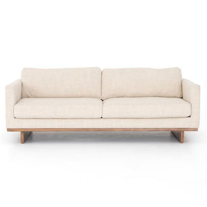 The Ethan Modern Classic Cream Performance Cushion Back Sofa is displayed with its minimalist design and wooden legs, featuring two large cushions for the backrest and two for the seats, all set against a white background.