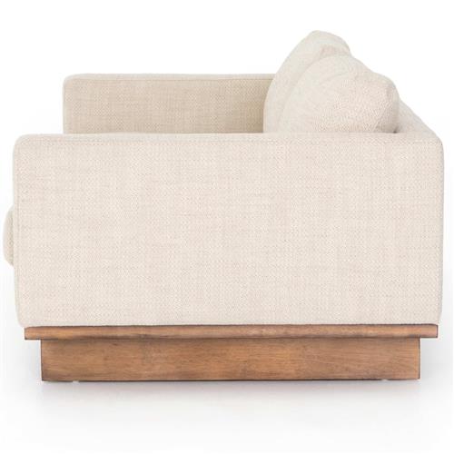 Side view of the Ethan Modern Classic Cream Performance Cushion Back Sofa, showcasing its sleek, rectangular design. It is equipped with thick cushioned armrests and a wooden base, offering a minimalist and contemporary aesthetic.