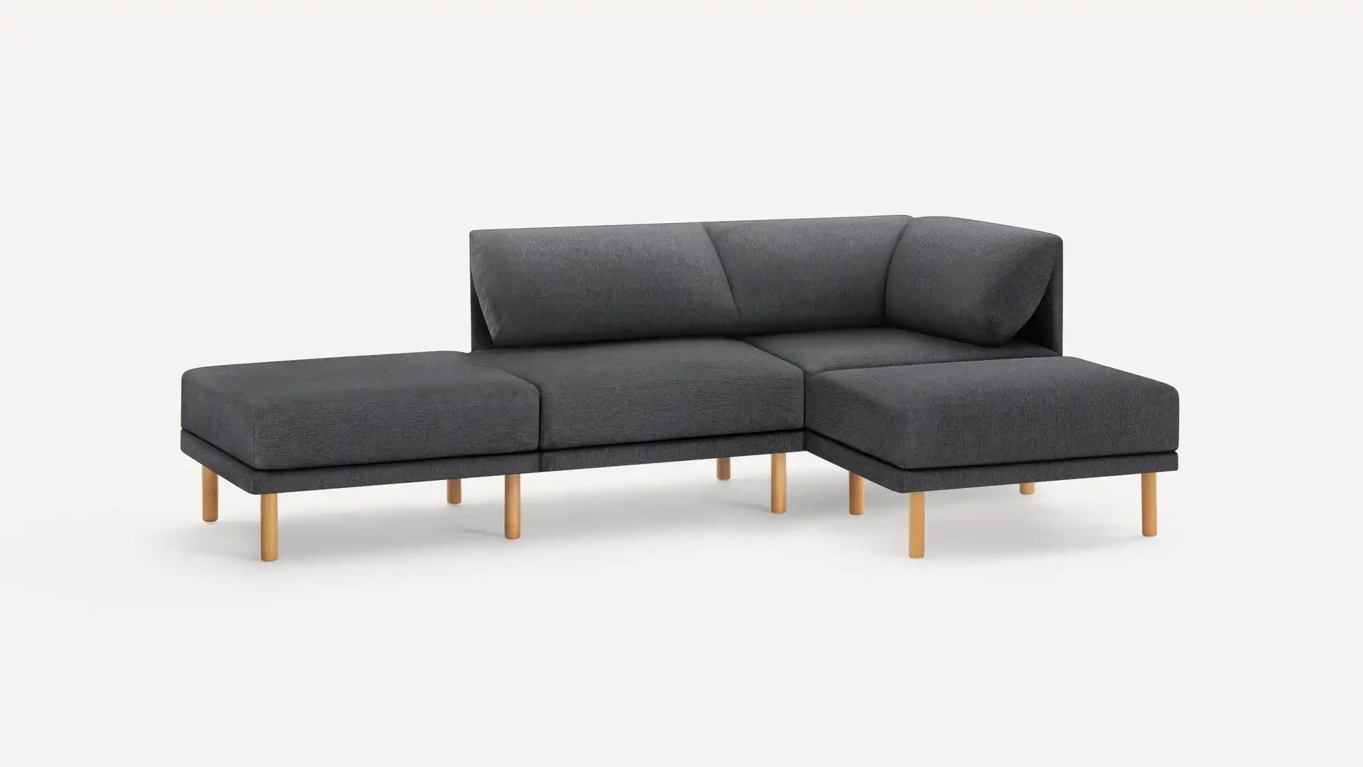 The Range Fabric 4-Piece Open Sectional Double Lounger Sofa is a modern piece with a minimalist design, featuring a sleek gray color and wooden legs. It includes a three-seat configuration along with an extended chaise lounge section, all set against a plain white background.