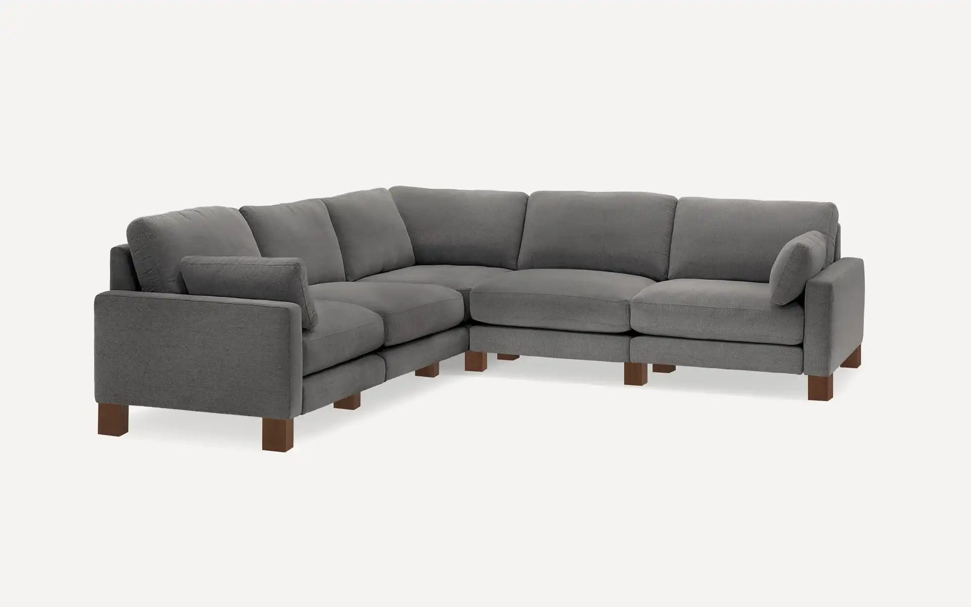 The Union Fabric Modular 5-Seat Sofa Sectional is a spacious and contemporary gray sectional with plush cushions and wooden legs, styled in an L-shape against a white background.