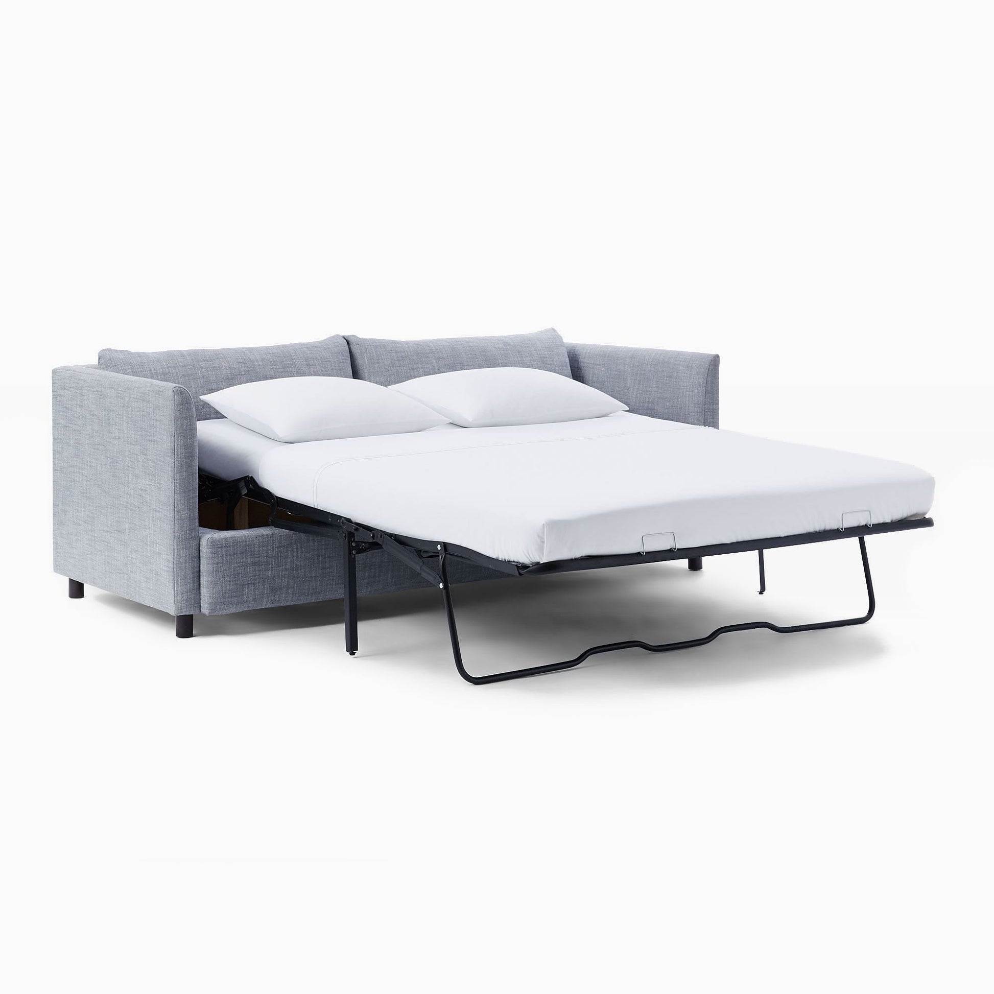 The Shelter Sleeper Sofa, in its modern gray design, features a pull-out bed that extends to reveal a neatly made white mattress. Two pillows rest on the bed, highlighting the sofa's versatility for both seating and sleeping.