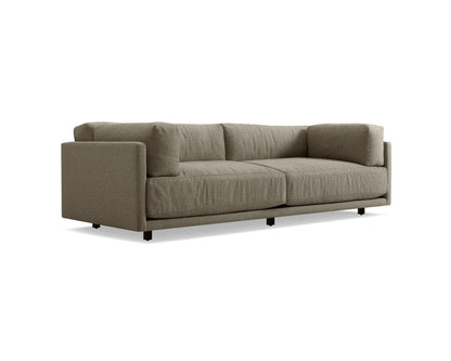 Introducing the Sunday 102-Inch Sofa, a modern piece in olive green with a minimalist aesthetic. It boasts two large seat cushions and complementary back pillows. The sofa features clean lines and rests on sleek black legs, all beautifully contrasted against a white background.