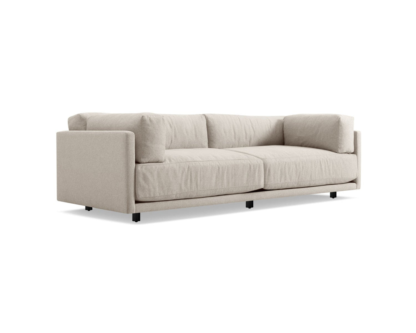 The Sunday 102-Inch Sofa is a modern piece in light beige with a minimalist design. It includes two large seat cushions and back cushions, supported by a sturdy frame with short black legs. The sofa showcases clean lines and has a soft, fabric finish.