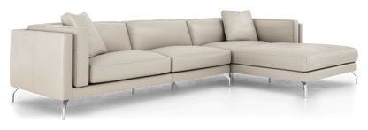 Introducing the Reade Sectional Sofa: a contemporary L-shaped design crafted in light beige leather. It showcases sleek, minimalist lines with chrome legs, and is complemented by matching back cushions and a pillow.