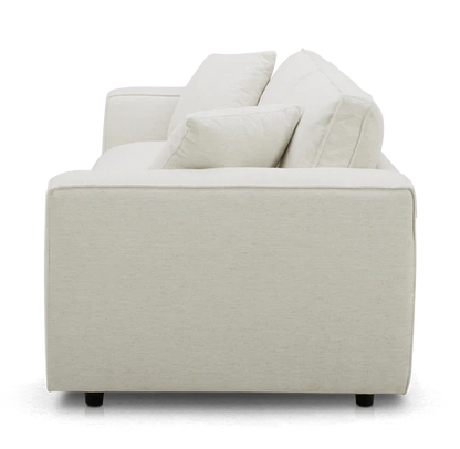 Side view of the Elmore Sofa, a modern beige piece with clean lines and two cushion accents. This sofa features a minimalist design and plush seating.