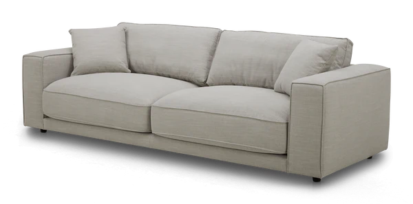 The Elmore Sofa, featuring a contemporary light gray design with plush cushions and wide armrests, is set against a black background.