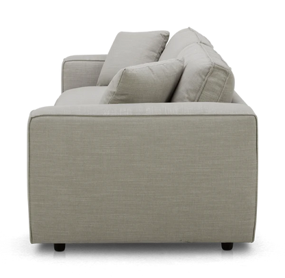 Side view of the Elmore Sofa in light gray fabric, featuring two seat cushions and two back cushions. The modern design rests on low, dark feet.