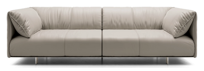 The Essex Sofa is a modern, minimalist piece featuring beige leather upholstery with smooth cushions and sleek, low-profile metal legs, elegantly displayed against a plain black background.