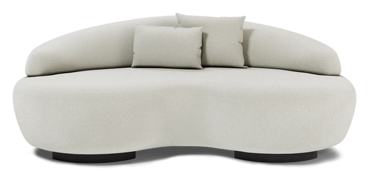 Introducing the Rio Sofa, a stylish, cream-colored piece with a curved silhouette and textured fabric finish. It includes two small matching cushions and a rounded backrest. This sofa boasts a unique wavy design with black base supports, seamlessly combining contemporary style and comfort.