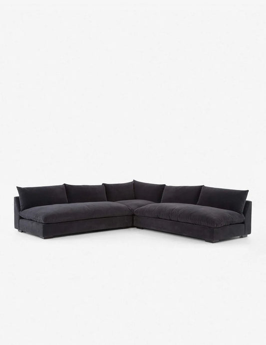 Introducing the Decima Sectional Sofa: a large, dark gray L-shaped piece with a modern design and thick cushions set against a plain white background.