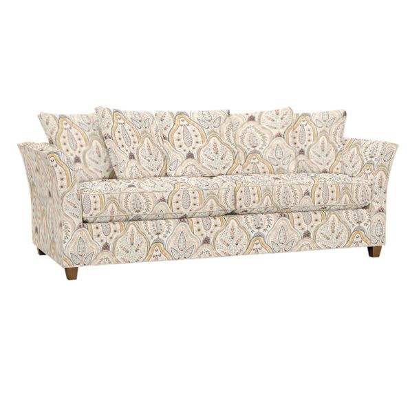 The Tate Queen Sleeper is a patterned sofa adorned with a paisley design in beige, blue, and gray tones. It comes with three seat cushions and several matching throw pillows, showcasing its wooden legs at the bottom.