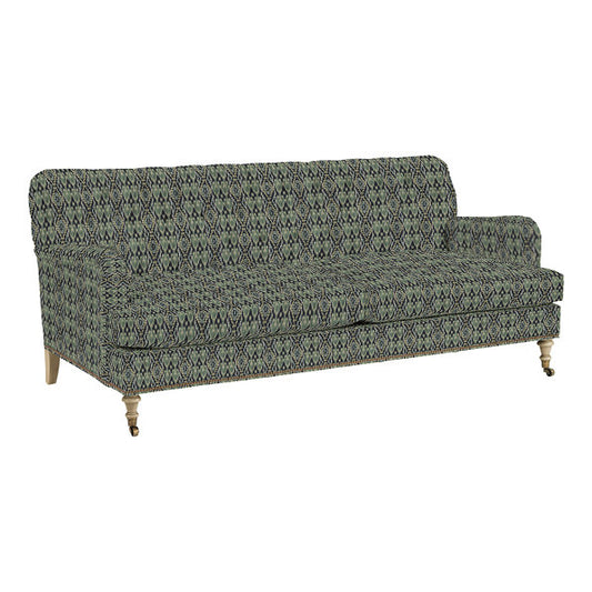 Introducing the Maggie Sofa with Brass Nailheads: This green and black patterned upholstered couch features wooden legs on wheels, showcasing a streamlined design with cushioned back and armrests, making it an ideal choice for a contemporary living room setting.