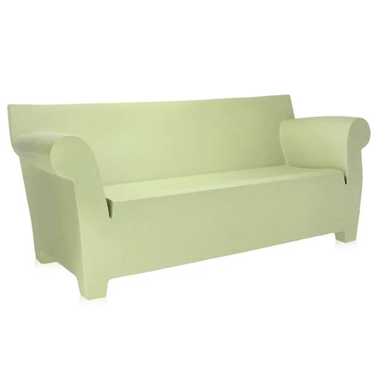 Introducing the Bubble Club Sofa by Kartell, a modern piece in light green that showcases a minimalist design. This sofa features rounded armrests and a slightly curved backrest, contributing to its sleek and contemporary aesthetic. The solid color accentuates its simple yet elegant appearance.