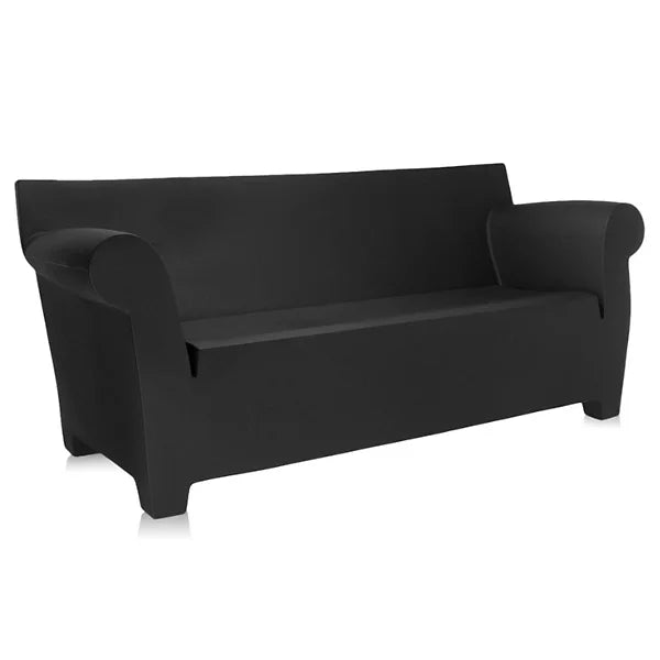 The Bubble Club Sofa by Kartell is presented in a sophisticated black with a modern aesthetic, showcasing rolled arms and a fitted cover, set against a minimalist white background.