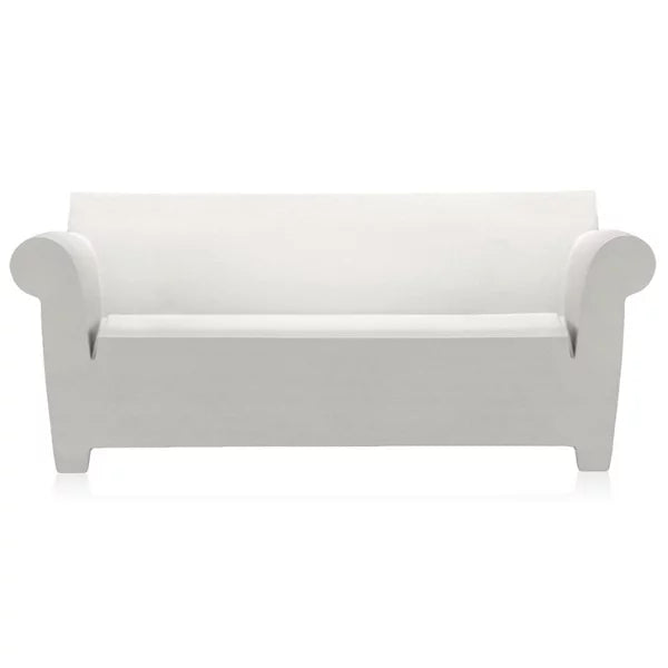 Introducing the Bubble Club Sofa by Kartell, a modern and minimalist piece featuring white color, curved armrests, and a flat backrest. Its simple and sleek design fits perfectly into contemporary interiors, while it stands proudly on short, block-like legs.