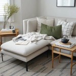 Cate St Hill lifestyle and home decor and interior design blog. Modern living room with white sofa and thin black metal cast iron legs, matching white ottoman, small square natural wood coffee table, Japanese teapot, natural wood side table, woven low pile patterned rug.