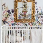 Flourishmentary lifestyle and home decor and interior design blog. Modern nursery decor with gold vintage antique mirror, watercolor flower wallpaper, fluted and rolled wooden crib, white peace dove mobile.