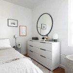Homey Oh My lifestyle and home decor and interior design blog. Clean minimalist modern bedroom with white IKEA dresser drawer, white natural linen sheets, argyle patterned black and white rug. Round black frame mirror.