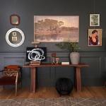 Jenny Komenda lifestyle and home decor and interior design blog. Slate gray Farrow and ball painted wall, gallery wall with vintage paintings. Oak wood accent side table with modern art. Argyle pattern gray woven rug.