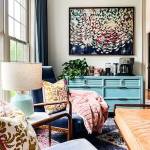 Kaleidoscope lifestyle and home decor and interior design blog. Sitting room with velvet upholstered blue armchairs, upholstered camel bench, seafoam green lamp, teal blue cabinet and coffee station, modern art.