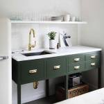 Remodelista lifestyle and home decor and interior design blog. Office kitchen renovation. Dark forest green painted cabinets, white marble countertop, gold fixtures and gold hardware. Open shelving. Vintage cream colored refrigerator.