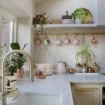 Swoon Worthy lifestyle and home decor blog. Modern kitchen with gold hardware, white marble countertops, pink appliances, pink mugs, and copper mugs.
