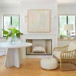 Young House Love blog interior decor. Living room and dining nook. White marble table, white rattan chair, embroidered poof.